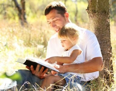 father-and-daughter-reading-bible-in-the-park